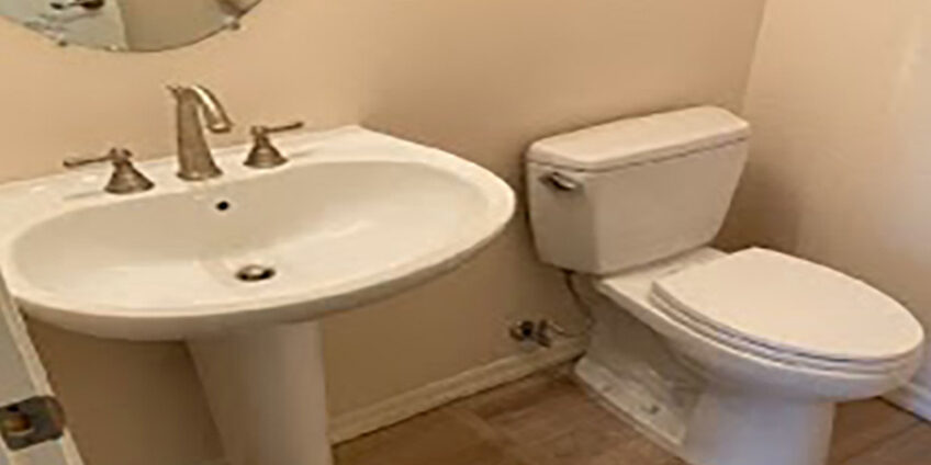 Plumber Fixing the Garbage Disposal