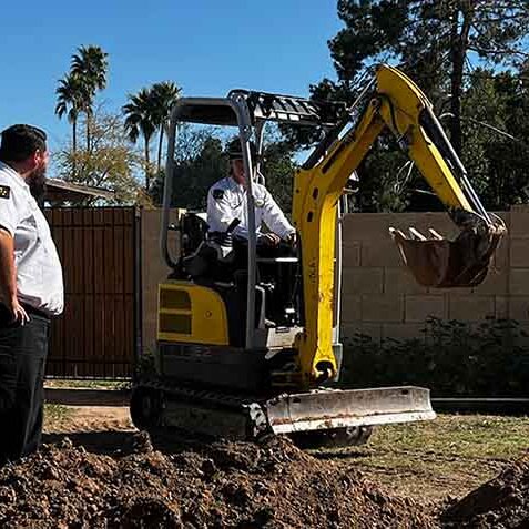 Professional Plumbers Doing Excavation Work